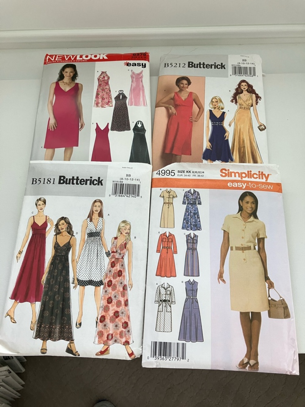Four uncut sewing patterns women’s dresses sizes 6–16